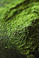 Moringa powder in close-up view showcasing its vibrant green color photo
