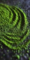 Moringa powder spread in creative swirls on a dark surface photo