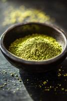 Moringa powder in a rustic bowl on a dark surface photo