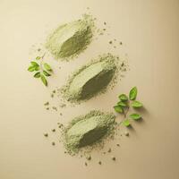 Moringa powder arranged on a neutral surface with leaves photo