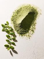 Moringa powder and leaves on a white surface for health benefits photo
