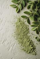 Moringa powder and fresh leaves create a vibrant green display photo