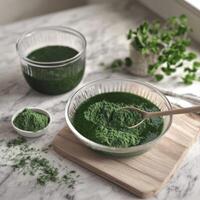 Moringa powder displayed in bowls with liquid extract nearby photo