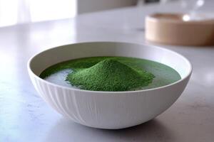 Moringa powder in a white bowl on a table with soft lighting photo