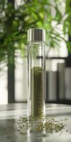 Moringa powder displayed in a glass container on a table photo