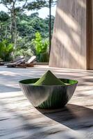 Moringa powder displayed in a green bowl near a modern setting photo