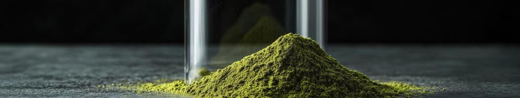 Moringa powder displayed in a glass container with a dark background photo