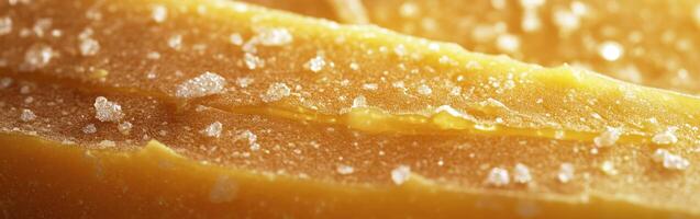 Gouda cheese with a golden hue and surface texture on display photo