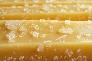 Gouda cheese with salt crystals on a wooden cutting board photo