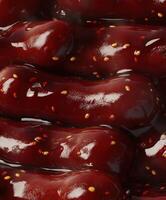 Tteokbokki dish served in a vibrant red sauce with sesame seeds photo