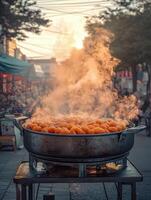 Steaming tteokbokki served in a bustling street market at sunset photo