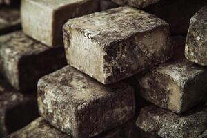 Blocks of goat cheese stacked in a rustic setting photo