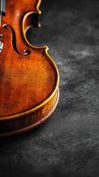 Elegant violin resting on a dark surface displaying fine craftsmanship photo