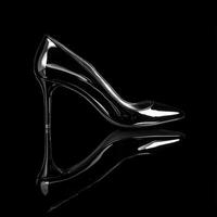 A black and white photo of a high heel shoe