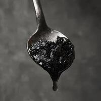 A spoon full of black coal photo