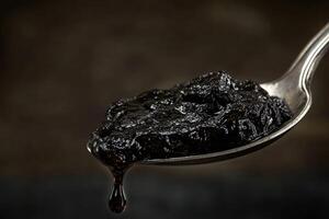 A spoon with a black substance on it photo