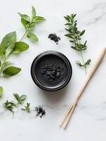 Natural shilajit resin surrounded by fresh herbs on a marble surface photo