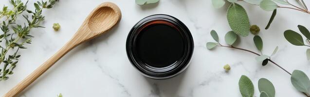 A spoon, a bowl and a spoon with eucalyptus leaves photo