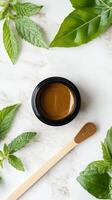Natural shilajit paste surrounded by fresh mint leaves photo