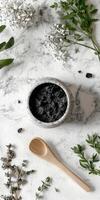 Shilajit resin in a decorative bowl on a marble surface with herbs photo