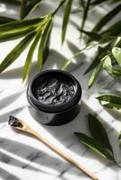 Natural shilajit preparation in a black container on marble surface photo