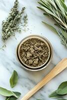 Shilajit powder surrounded by fresh herbs on a marble surface photo