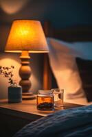 Shilajit jar on bedside table next to glass of water at night photo