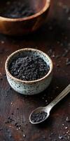 Natural shilajit resin in a decorative bowl with a spoon photo
