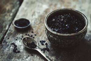 Natural shilajit resin in a decorative bowl on wooden table photo