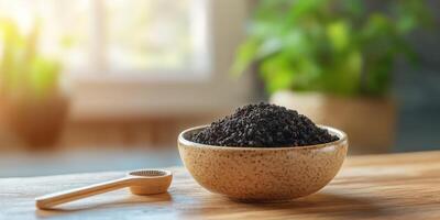 Shilajit powder displayed in a rustic bowl with spoon photo