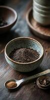 Shilajit powder in a rustic bowl on a wooden table photo