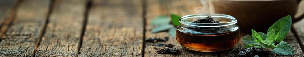 Natural shilajit preparation with herbal elements on wooden surface photo