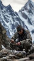 Gathering shilajit from rocky terrain in the mountains photo