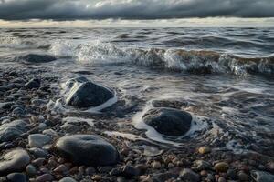 Rippling river water flows over stones under a cloudy sky photo