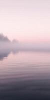 Misty river water reflects soft morning light at dawn photo
