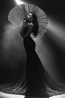 Elegant woman posing with a fan in dramatic lighting photo