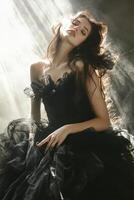 Model in elegant black dress surrounded by ethereal light photo