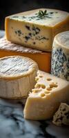Cheese platter with various types of cheese on a marble surface photo