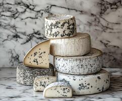 Assorted artisanal cheeses displayed on a marble countertop photo