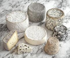Assorted artisanal cheeses arranged on a marble surface photo