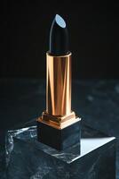 Black lipstick elegantly displayed on a reflective surface photo