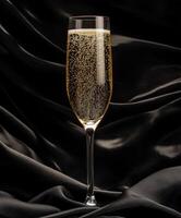 Sparkling beverage served in an elegant glass against black fabric photo