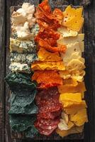 Colorful assortment of cheeses and meats on a wooden board photo