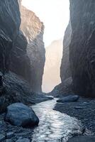 Mountain river flowing through a narrow canyon at dawn, revealing towering rock formations and misty surroundings photo