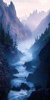 Flowing mountain river through misty valleys at sunrise with rugged peaks in the background photo