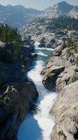 Mountain river cascading through rocky terrain with clear water glistening under sunlight photo