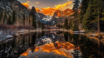 Mountain river reflects vibrant sunset over snow-capped peaks in Colorado photo