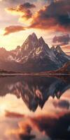 Stunning sunset over a tranquil mountain river reflecting the peaks and clouds in a serene landscape photo
