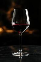 Elegant wine glass showcasing deep red wine, reflecting light in a cozy ambiance near a flickering fireplace photo