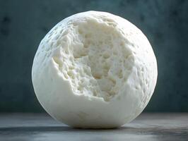 Explore the texture and form of fresh mozzarella on a rustic table background photo